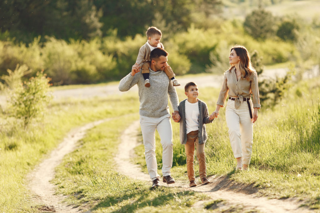 A family of four happily walking together